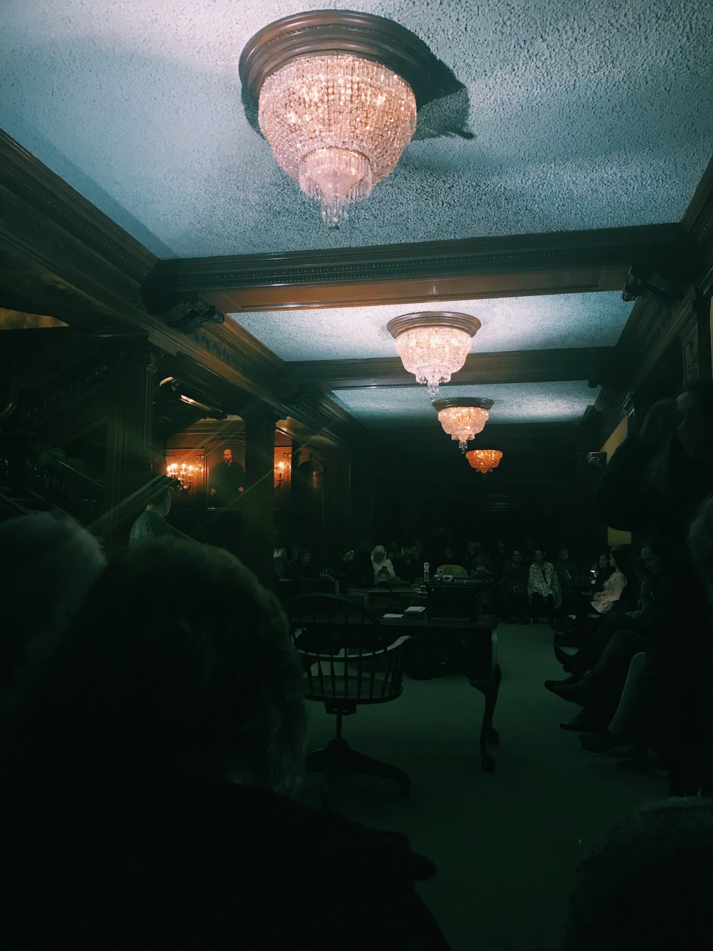 Foyer with chandeliers and staircase.