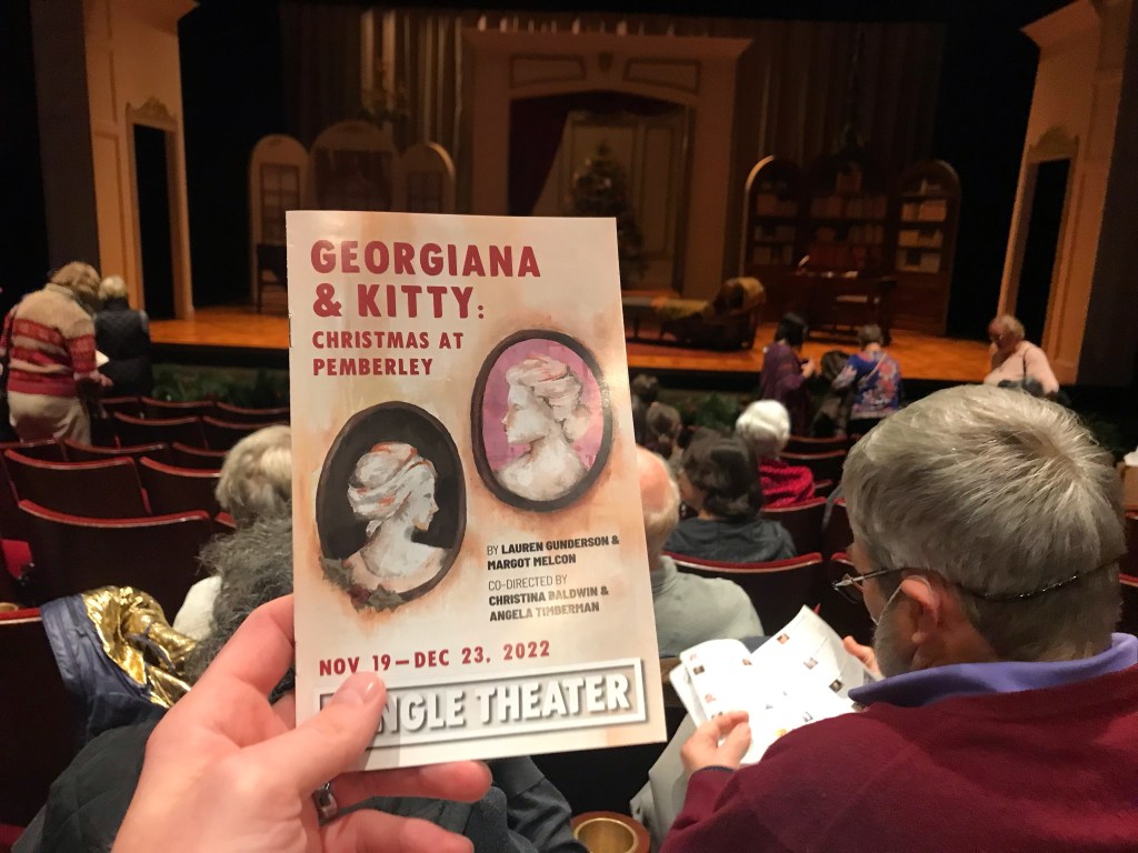 Holding a program for the holiday play "Georgiana & Kitty: Christmas at Pemberley," a sequel to Jane Austen's "Pride & Prejudice," currently playing at the Jungle Theater in Minneapolis